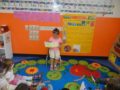 preschool_girl_reading_to_class_creative_kids_childcare_centers_kent-600x450