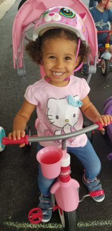 preschool_girl_riding_bike_in_helmet_winwood_childrens_center_gainesville_ii_va-219x450