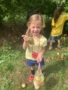 preschool_girl_showing_off_an_apple_during_field_trip_creative_kids_childcare_centers_mahopac-338x450