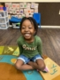 preschool_girl_sitting_on_rug_and_smiling_sunbrook_academy_at_legacy_park-338x450