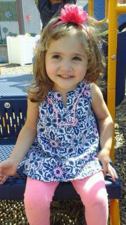 preschool_girl_sitting_on_the_playground_prime_time_early_learning_centers_farmingdale_ny-253x450