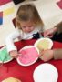 preschool_girl_spooning_out_food_at_cadence_academy_preschool_ken_caryl_littleton_co-338x450