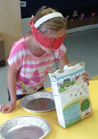 preschool_girl_taking_drink_from_cereal_box_at_cadence_academy_preschool_ken_caryl_littleton_co-316x450