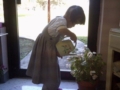 preschool_girl_watering_plant_smaller_scholars_montessori_academy_grisby_tx-600x450