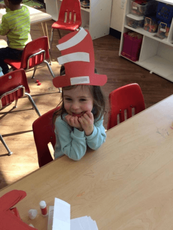 preschool_girl_wearing_cat_in_the_hat_craft_cadence_academy_preschool_lincoln_ri-338x450