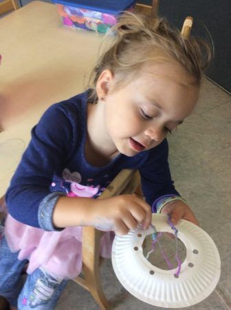 preschool_girl_weaving_dream_catcher_cadence_academy_preschool_tumwater_wa-336x450