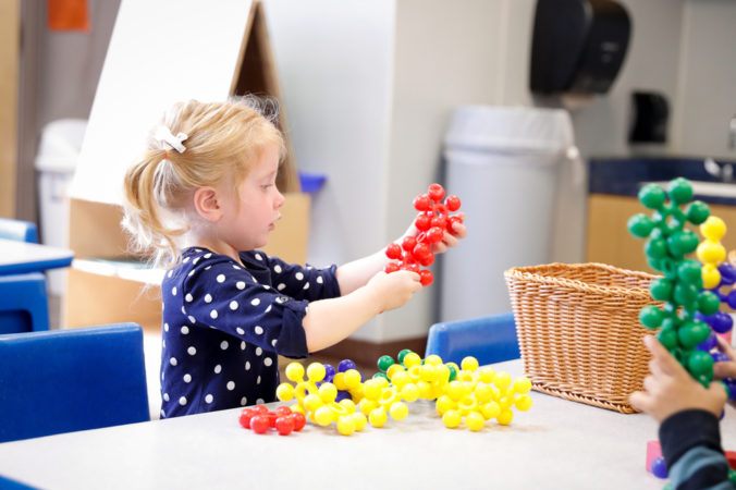 preschool_girl_with_manipulatives_cadence_academy_montgomery_il-676x450