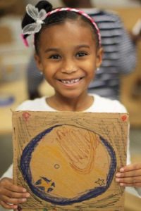 preschool_girl_with_map_of_the_world_cadence_academy_preschool_steele_creek_charlotte_nc-300x450