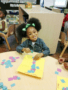 preschool_girl_with_small_square_art_project_sunbrook_academy_at_chapel_hill_douglasville_ga-338x450