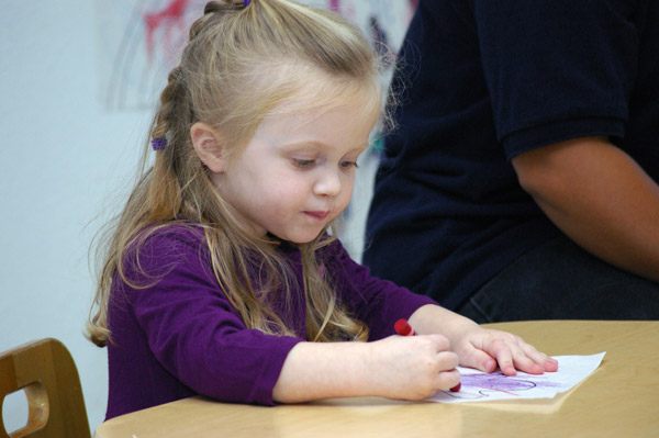 preschool_girl_writing_cadence_academy_preschool_fayetteville_ar