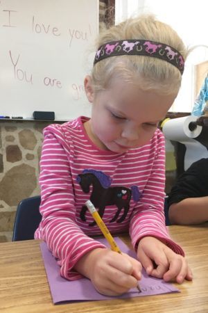 preschool_girl_writing_thank_you_note_canterbury_academy_at_shawnee_crossings_shawnee_ks-300x450