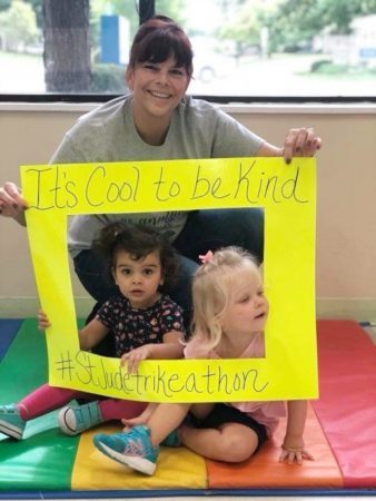 preschool_girls_and_teacher_celebrating_st_jude_trike-a-thon_cadence_academy_chesterfield_mo-338x450