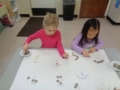 preschool_girls_counting_with_quarters_cadence_academy_preschool_clive_ia-600x450
