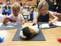 preschool_girls_doing_art_project_with_guinea_pig_bearfoot_lodge_private_school_wylie_tx-600x450
