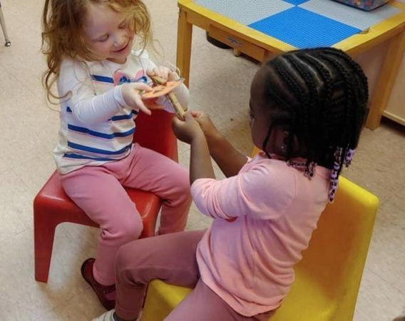 preschool_girls_doing_clothespin_activity_prime_time_early_learning_centers_middletown_ny-568x450