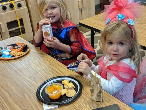 preschool_girls_eating_lunch_in_costumes_canterbury_academy_at_prairie_ridge_olathe_ks-600x450