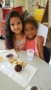 preschool_girls_enjoying_snack_at_cadence_academy_preschool_rosemeade_carrollton_tx-253x450