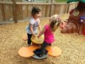 preschool_girls_enjoying_teeter_totter_cadence_academy_preschool_dupont_wa-600x450