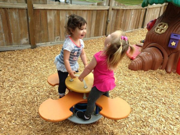 preschool_girls_enjoying_teeter_totter_cadence_academy_preschool_dupont_wa-600x450