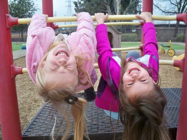 preschool_girls_hanging_upside_down_at_cadence_academy_preschool_broadstone_folsom_ca-600x450