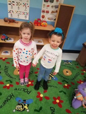 preschool_girls_holding_hands_during_dominican_republic_celebration_prime_time_early_learning_centers_farmingdale_ny-338x450