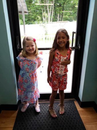 preschool_girls_in_floral_outfits_near_door_cadence_academy_preschool_lincoln_ri-338x450