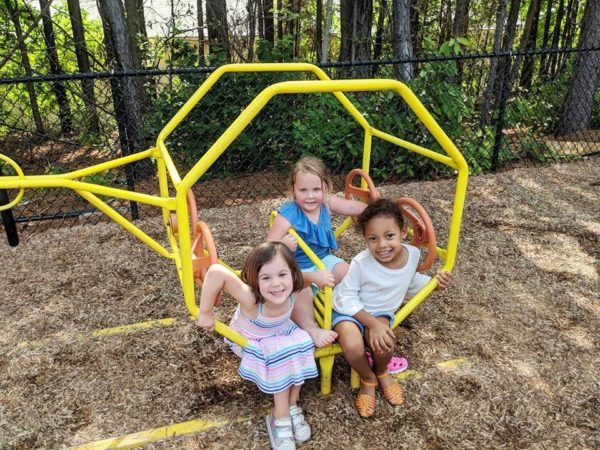 preschool_girls_on_helicopter_playground_equipment_carolina_kids_child_development_center_rock_hill_sc-600x450