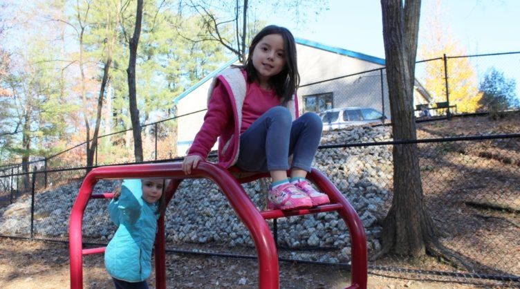 preschool_girls_on_monkey_bars_cadence_academy_preschool_smithfield_ri-752x418