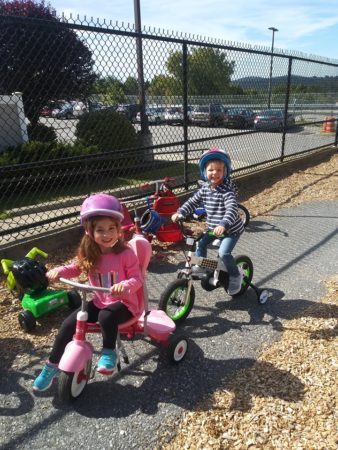 preschool_girls_on_tricycles_creative_kids_childcare_centers_brewster-338x450