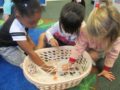 preschool_girls_picking_up_spiders_with_tweezers_winwood_childrens_center_reston_va-600x450