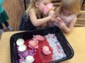 preschool_girls_playing_with_flowers_cadence_academy_preschool_austin_cedar_park_tx-600x450