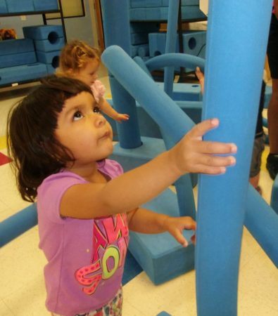 preschool_girls_playing_with_large_tubes_and_blocks_cadence_academy_preschool_centennial_co-395x450