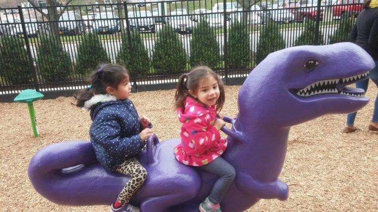 preschool_girls_riding_purple_dinosaur_on_playground_prime_time_early_learning_centers_paramus_nj-752x423