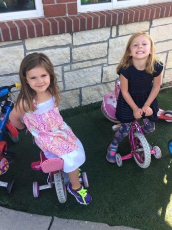 preschool_girls_sitting_on_bikes_canterbury_academy_at_shawnee_crossings_shawnee_ks-338x450