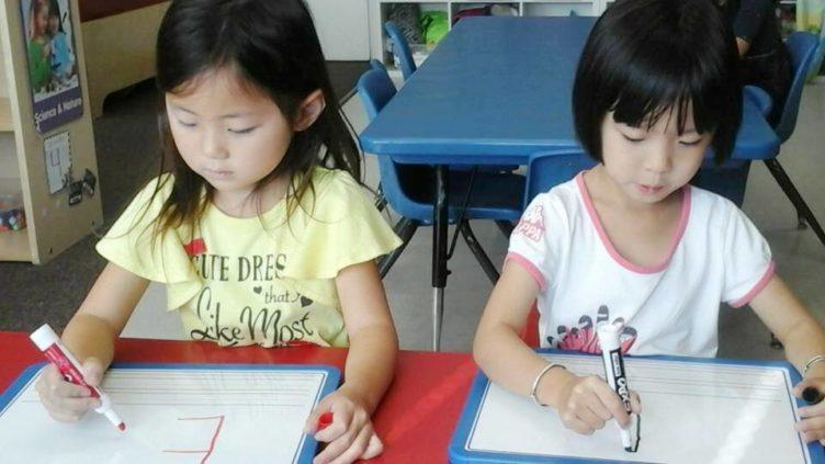preschool_girls_writing_the_letter_e_prime_time_early_learning_centers_edgewater_nj-752x423