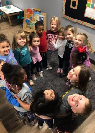 preschool_group_hug_at_cadence_academy_preschool_branch_hollow_carrollton_tx-322x450