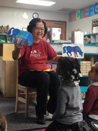 preschool_teacher_reading_book_to_class_rogys_learning_place_big_hollow_peoria_il-338x450