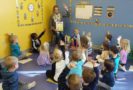 preschool_teacher_reading_book_to_preschool_children_canterbury_academy_at_small_beginnings_overland_park_ks-664x450