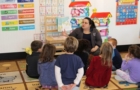 preschool_teacher_reading_to_students_cadence_academy_preschool_east_greenwich_ri-698x450