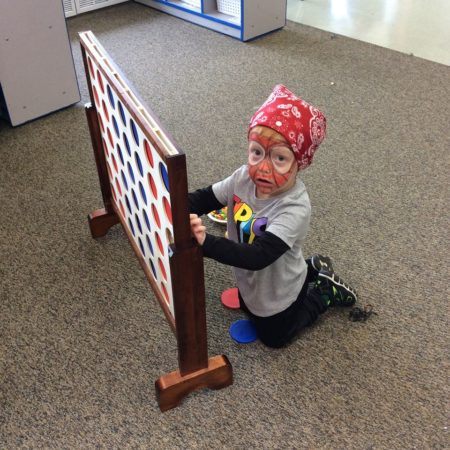 preschooler_in_spiderman_outfit_playing_connect_4_cadence_academy_preschool_burr_ridge_il-450x450