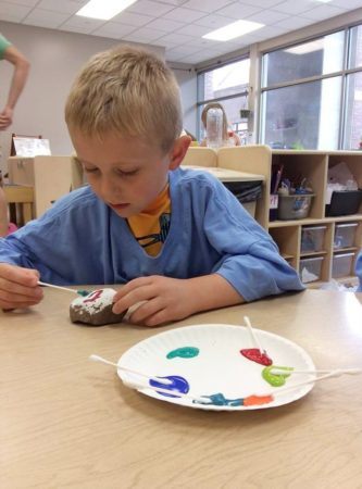 preschooler_painting_rock_with_q-tips_cadence_academy_preschool_iowa_city_ia-333x450