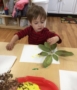 preschooler_painting_with_leaf_cadence_academy_preschool_east_greenwich_ri-387x450