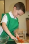preschooler_peeling_a_carrot_at_smaller_scholars_montessori_academy_gilbert_az-300x450