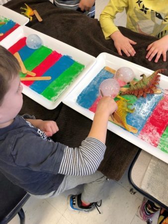 preschooler_playing_with_balls_of_ice_winwood_childrens_center_gainesville_va-338x450