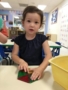 preschooler_playing_with_magnetic_triangles_cadence_academy_preschool_grand_west_des_moines_ia-338x450