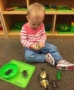 preschooler_playing_with_plastic_bugs_canterbury_academy_at_prairie_ridge_olathe_ks-371x450