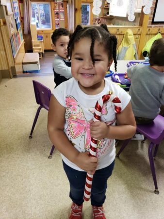 preschooler_with_large_candy_cane_cadence_academy_preschool_portland_or-338x450