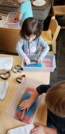 preschoolers_doing_sensory_activity_cadence_academy_preschool_childrens_center_klamath_falls_or-218x450