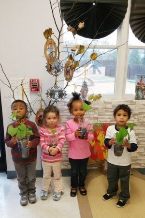 preschoolers_holding_plants_cadence_academy_northlake_charlotte_nc-300x450
