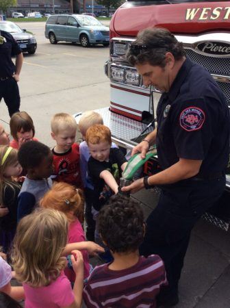 preschoolers_investigating_fire_hose_cadence_academy_preschool_ashworth_west_des_moines_ia-336x450